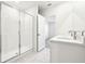 Bright bathroom featuring a glass shower and double sink vanity at 31632 Malbec Dr, Brooksville, FL 34602