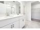 Modern bathroom featuring double sinks and a walk-in shower, designed for style and convenience at 31632 Malbec Dr, Brooksville, FL 34602