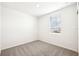 This bedroom is light and airy with neutral carpet and a window with blinds at 31632 Malbec Dr, Brooksville, FL 34602