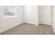 This is a bedroom featuring neutral carpet, a window with blinds, and a closet at 31632 Malbec Dr, Brooksville, FL 34602