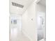 Bright hallway showcasing tile flooring, white walls, and a view into a carpeted room at 31632 Malbec Dr, Brooksville, FL 34602