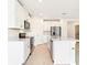 Modern kitchen with stainless steel appliances, white cabinets, an island and ample counter space, ideal for cooking at 31632 Malbec Dr, Brooksville, FL 34602