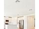 Bright kitchen features stainless steel appliances, white cabinets, and a kitchen island at 31632 Malbec Dr, Brooksville, FL 34602