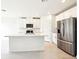 This is a kitchen featuring stainless steel appliances, white cabinets, and a center island at 31632 Malbec Dr, Brooksville, FL 34602