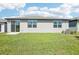 Well-maintained backyard showcasing the home's rear exterior with sliding glass doors at 31668 Wild Grape Ln, Brooksville, FL 34602