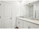 Clean bathroom featuring a double vanity with granite countertop and a large mirror at 31668 Wild Grape Ln, Brooksville, FL 34602