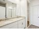 Bright bathroom with a double sink vanity, granite countertops, and a glass-enclosed shower at 31668 Wild Grape Ln, Brooksville, FL 34602