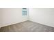 This is a secondary bedroom with carpeted floors, a window and white walls at 31668 Wild Grape Ln, Brooksville, FL 34602