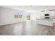 Bright open-concept living space with tile flooring and sliding glass doors leading to the backyard at 31668 Wild Grape Ln, Brooksville, FL 34602