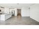 Open concept living room and kitchen includes stainless steel appliances and island with granite countertops at 31668 Wild Grape Ln, Brooksville, FL 34602