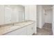 Bathroom with double sink vanity, granite countertop, and walk-in closet at 3553 Moscato Dr, Brooksville, FL 34602