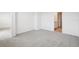 Neutral bedroom with gray carpet, showing bathroom and closet access at 3553 Moscato Dr, Brooksville, FL 34602