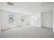 Large, carpeted bonus room with natural light from multiple windows at 3553 Moscato Dr, Brooksville, FL 34602