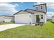 Charming two-story home with a well-manicured lawn and attached two-car garage at 3553 Moscato Dr, Brooksville, FL 34602