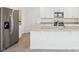 An open kitchen has stainless steel appliances, granite countertops and white cabinets at 3553 Moscato Dr, Brooksville, FL 34602