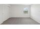 Bright bedroom features plush carpeting, a window for natural light, and a spacious closet at 3634 Moscato Dr, Brooksville, FL 34602