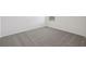 Neutral-toned room features carpet, a window and white trim at 3634 Moscato Dr, Brooksville, FL 34602