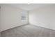 Neutral bedroom featuring a window with blinds and plush carpeting for comfort at 3634 Moscato Dr, Brooksville, FL 34602