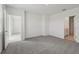 A spacious bedroom with neutral carpet, white walls and connecting bathroom and walk-in closet at 3634 Moscato Dr, Brooksville, FL 34602