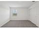 Bright bedroom with plush carpeting, a window, and a closet offering ample storage at 3634 Moscato Dr, Brooksville, FL 34602