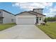 New home with a two-car garage, front yard landscaping, and modern architectural features at 3634 Moscato Dr, Brooksville, FL 34602