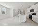 Open-concept kitchen features white cabinets, stainless steel appliances, and a large island at 3634 Moscato Dr, Brooksville, FL 34602