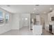 Open-concept kitchen with white cabinets, stainless steel appliances, and island at 3634 Moscato Dr, Brooksville, FL 34602