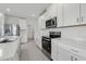 Kitchen featuring white cabinets, stainless steel appliances, and large island at 3634 Moscato Dr, Brooksville, FL 34602