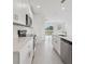 A modern kitchen with stainless steel appliances, white cabinets, and a center island at 3634 Moscato Dr, Brooksville, FL 34602