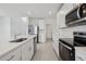 Kitchen featuring white cabinets, stainless steel appliances, and large island at 3634 Moscato Dr, Brooksville, FL 34602