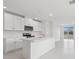 Bright kitchen features white cabinets, an island with sink and stainless steel appliances at 3634 Moscato Dr, Brooksville, FL 34602