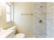 Bathroom with tiled shower, modern fixtures, and window at 777 27Th S Ave, St Petersburg, FL 33705