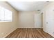 Bright bedroom featuring wood-look floors, a window with blinds, and white doors at 777 27Th S Ave, St Petersburg, FL 33705
