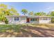 Lovely single-story home with a red front door and mature landscaping; perfect for a comfortable lifestyle at 777 27Th S Ave, St Petersburg, FL 33705