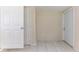 Hallway with white tile flooring and two white doors at 777 27Th S Ave, St Petersburg, FL 33705