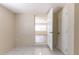 Hallway leading into living area featuring white tile flooring and two white doors at 777 27Th S Ave, St Petersburg, FL 33705