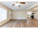 Inviting living room featuring new floors, ceiling fan, and an adjacent kitchen; perfect for hosting and cooking at 777 27Th S Ave, St Petersburg, FL 33705