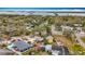 A high-angle aerial view showcasing the neighborhood, nearby water, and lush greenery at 8135 33Rd Ave N, St Petersburg, FL 33710