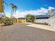 Spacious backyard featuring mature palm trees, gravel ground cover, and a partial concrete patio at 8135 33Rd Ave N, St Petersburg, FL 33710