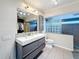 Modern bathroom featuring a double sink vanity and a glass block window for added privacy at 8135 33Rd Ave N, St Petersburg, FL 33710