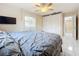 Bright bedroom features a comfortable bed, ceiling fan, and a view into the hallway at 8135 33Rd Ave N, St Petersburg, FL 33710