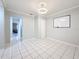 Bonus room features white tile floor; adjacent to other rooms, offering flexible space at 8135 33Rd Ave N, St Petersburg, FL 33710