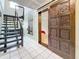 Welcoming entryway with modern staircase and a unique carved wooden sliding door leading to another room at 8135 33Rd Ave N, St Petersburg, FL 33710