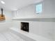 Fireplace painted white, creating a calming space; a guitar hangs nearby on the wall at 8135 33Rd Ave N, St Petersburg, FL 33710