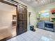 Convenient laundry room featuring modern appliances and a decorative sliding barn door to the Primary walk-in closet at 8135 33Rd Ave N, St Petersburg, FL 33710