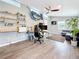 Inviting living room with wood floors, ceiling fan, work space, mounted marlin, and comfortable seating at 8135 33Rd Ave N, St Petersburg, FL 33710