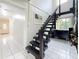Modern staircase with dark wood steps, metal railings, and an open design; good natural lighting at 8135 33Rd Ave N, St Petersburg, FL 33710