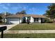 Charming single-story home with a well-maintained lawn and attached two-car garage at 382 Waterford E Cir, Tarpon Springs, FL 34688