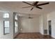 Spacious living room with large windows, ceiling fans, and tile floors at 382 Waterford E Cir, Tarpon Springs, FL 34688