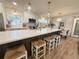 Modern kitchen with stainless steel appliances, a large island, and pendant lighting, great for cooking and entertaining at 5972 5Th S Ave, St Petersburg, FL 33707